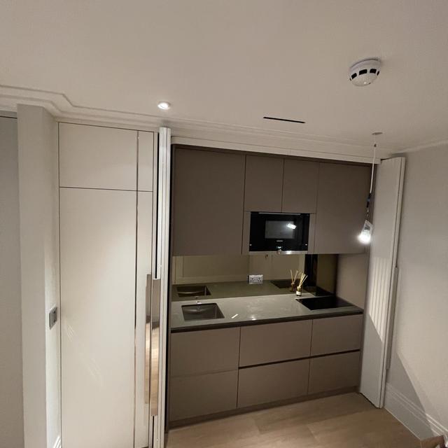 Concealed kitchenette with pocket doors - premium studio finish