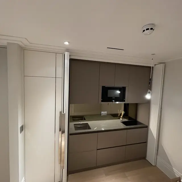 Concealed kitchenette with pocket doors - premium studio finish